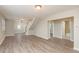 Spacious living area with wood-look floors, staircase access, and neutral paint at 49 W Boyer St, Tarpon Springs, FL 34689
