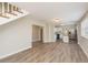 Open living area featuring a staircase, wood-look floors, and seamless transition to kitchen at 49 W Boyer St, Tarpon Springs, FL 34689
