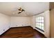 Cozy bedroom featuring hardwood floors, recessed lighting, and a large window with sheer white curtains at 1570 Preserve Way, Clearwater, FL 33764