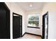 Hallway with a natural light-filled window with views of exterior landscaping at 1570 Preserve Way, Clearwater, FL 33764