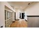 Hallway with built-in shelving units, tile flooring, and a view of multiple doorways at 1570 Preserve Way, Clearwater, FL 33764