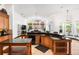 Open kitchen with wooden cabinets, granite countertops, and views of the outdoor pool at 1570 Preserve Way, Clearwater, FL 33764