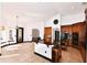 Spacious open kitchen with wood cabinets, black countertops, stainless appliances, and tile flooring at 1570 Preserve Way, Clearwater, FL 33764