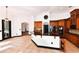 Open kitchen with custom wood cabinets, stainless appliances, black countertops and access to the dining room at 1570 Preserve Way, Clearwater, FL 33764