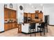 Kitchen featuring wooden cabinets, granite countertops, and black barstool seating at 1570 Preserve Way, Clearwater, FL 33764