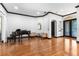 Elegant living room featuring hardwood floors, contrasting trim, and glass doors leading to the outside at 1570 Preserve Way, Clearwater, FL 33764