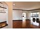 Open-concept living space with hardwood floors, contrasting trim, and a view of the pool through sliding doors at 1570 Preserve Way, Clearwater, FL 33764