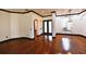 Bright living room with hardwood floors, contrasting trim, black door and windows, and modern lighting fixture at 1570 Preserve Way, Clearwater, FL 33764