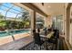 Outdoor dining area with a view of the pool and lush landscaping at 1570 Preserve Way, Clearwater, FL 33764