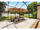Comfortable patio furniture with an umbrella creates a relaxing space at 1570 Preserve Way, Clearwater, FL 33764