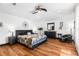Main bedroom with king bed, hardwood floors, and ceiling fan at 1570 Preserve Way, Clearwater, FL 33764