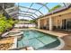 Inviting pool and spa area with a covered patio and lush landscaping at 1570 Preserve Way, Clearwater, FL 33764