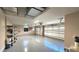 Two-car garage with epoxy flooring and ample storage shelving at 1570 Preserve Way, Clearwater, FL 33764