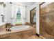 Spa-like bathroom with soaking tub, walk-in shower, and tile flooring at 1570 Preserve Way, Clearwater, FL 33764
