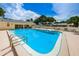 Community pool with plenty of lounge chairs and patio tables at 2465 Northside Dr # 702, Clearwater, FL 33761