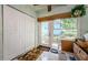 Laundry area with built-in storage, tile floors, and a door leading outside at 2465 Northside Dr # 702, Clearwater, FL 33761
