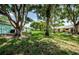 Community backyard with lush landscaping and mature trees providing shade at 2465 Northside Dr # 702, Clearwater, FL 33761