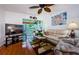 Comfortable living room featuring hardwood floors, a ceiling fan, and access to a patio at 2465 Northside Dr # 702, Clearwater, FL 33761