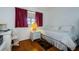 Bright bedroom with wood floors, double bed, and built-in desk at 2465 Northside Dr # 702, Clearwater, FL 33761