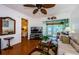 Living area with hardwood floors, a beige sofa, and views into the bedroom at 2465 Northside Dr # 702, Clearwater, FL 33761
