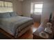 Bedroom with double bed, dresser and wood floors at 29 Concord Ln # 11, Palm Harbor, FL 34684