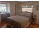 Bedroom with double bed, dresser, and wood floors at 29 Concord Ln # 11, Palm Harbor, FL 34684