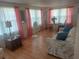 Living room with light wood floors, sofa, and dining table at 29 Concord Ln # 11, Palm Harbor, FL 34684