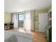 Bedroom with hardwood floors, access to a balcony and a view at 150 Belleview Blvd # 704, Belleair, FL 33756