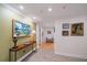 Bright hallway with hardwood floors and elegant wall art at 150 Belleview Blvd # 704, Belleair, FL 33756