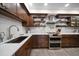 Modern kitchen with stainless steel appliances and quartz countertops at 150 Belleview Blvd # 704, Belleair, FL 33756