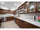 Modern kitchen with wood cabinets, granite counters, and stainless steel appliances at 150 Belleview Blvd # 704, Belleair, FL 33756