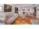 Open living and dining area with hardwood floors, neutral colors, and a view into the kitchen at 150 Belleview Blvd # 704, Belleair, FL 33756