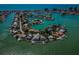 Expansive aerial view of homes on a peninsula, showcasing stunning waterfront properties, and scenic surroundings at 526 Belle Isle Ave, Belleair Beach, FL 33786