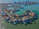 Stunning aerial view showcasing the beautiful homes on a peninsula surrounded by stunning waters and lush landscapes at 526 Belle Isle Ave, Belleair Beach, FL 33786