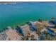 Aerial view showcasing waterfront homes, each with private docks, set against the backdrop of expansive ocean views at 526 Belle Isle Ave, Belleair Beach, FL 33786