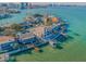 Panoramic aerial shot showcasing a waterfront home on a peninsula, complete with a private boat dock and lush surroundings at 526 Belle Isle Ave, Belleair Beach, FL 33786