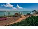 Landscaped yard with dock and water at 526 Belle Isle Ave, Belleair Beach, FL 33786