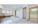 Bright bathroom featuring a large soaking tub, glass-enclosed shower, and wood-trimmed doors at 526 Belle Isle Ave, Belleair Beach, FL 33786