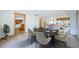 Bright dining room with seating for six and views of the adjacent living spaces and kitchen at 526 Belle Isle Ave, Belleair Beach, FL 33786
