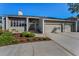 Charming single-story home featuring a spacious driveway and lush landscaping at 526 Belle Isle Ave, Belleair Beach, FL 33786