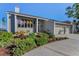 Well-maintained home with a spacious driveway and mature green landscaping at 526 Belle Isle Ave, Belleair Beach, FL 33786