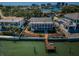 Waterfront property featuring a private dock, beautiful landscaping, and a charming two-story home with a spacious covered porch at 526 Belle Isle Ave, Belleair Beach, FL 33786