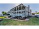 Home exterior featuring lawn, landscaping, and covered deck at 526 Belle Isle Ave, Belleair Beach, FL 33786