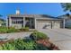 Inviting single-story home featuring a spacious driveway and beautiful landscaping at 526 Belle Isle Ave, Belleair Beach, FL 33786