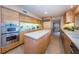 Bright kitchen with an island, stainless steel appliances, and ample counter space at 526 Belle Isle Ave, Belleair Beach, FL 33786