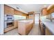 Bright kitchen features an island, stainless steel appliances, and ample counter space at 526 Belle Isle Ave, Belleair Beach, FL 33786