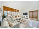 Bright living room with white sofas, neutral rug, and natural light from the large windows at 526 Belle Isle Ave, Belleair Beach, FL 33786