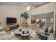 Bright, open living room with vaulted ceiling, neutral tones, and a decorative potted tree at 526 Belle Isle Ave, Belleair Beach, FL 33786