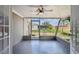Screened porch with ceiling fan and view of backyard at 3353 Columbus Dr, Holiday, FL 34691