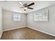 Spacious bedroom with wood-look flooring and ceiling fan at 3353 Columbus Dr, Holiday, FL 34691
